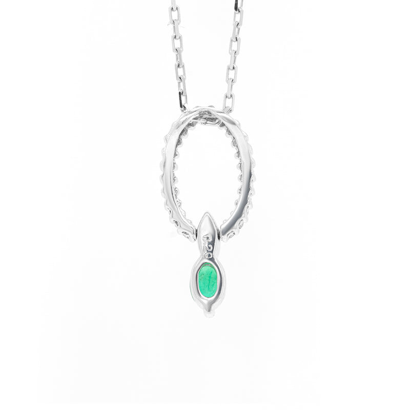 Back of An 18 carat white gold oval pendant featuring a central emerald, surrounded by round brilliant cut diamonds set in a claw-like design.