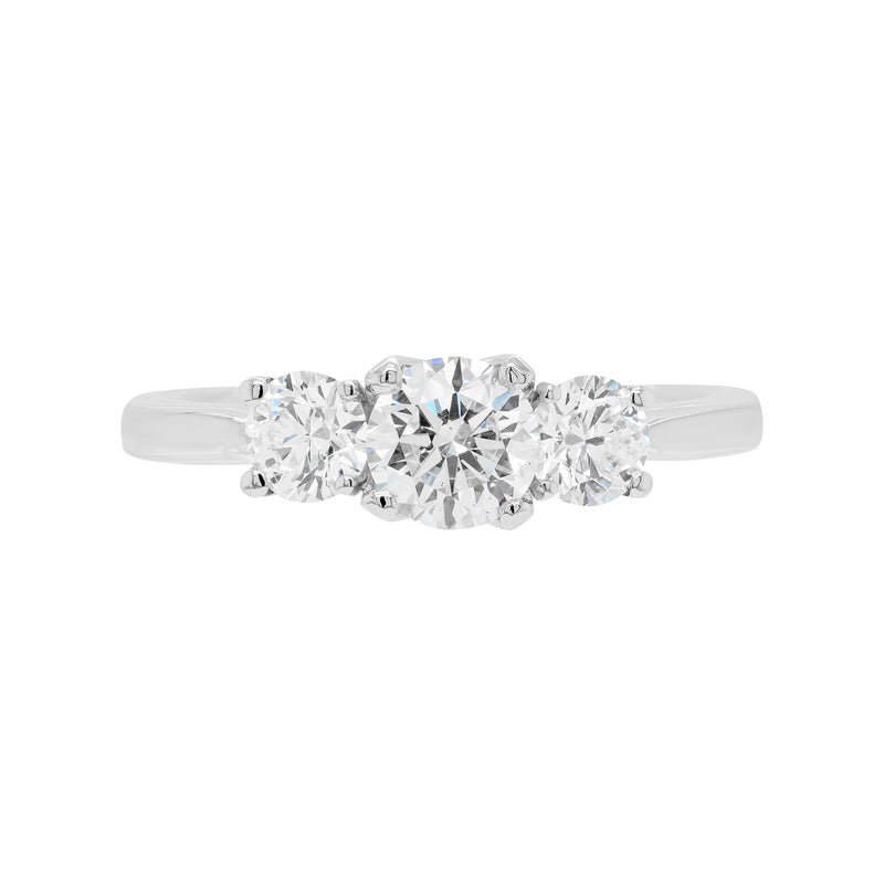 A platinum engagement ring with a central round brilliant cut diamond and two smaller round cut diamonds on the sides, set in an open-work gallery.