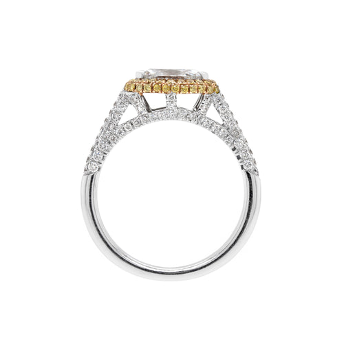A marquise diamond engagement ring with an east west setting  halo of round yellow diamonds set in rose gold, with smaller white round brilliant cut diamonds set in a contrasting band of platinum. side view