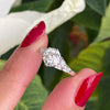 a 0.95 Carat Old Cut Diamond Engagement Ring with 6 smaller diamonds set in Platinum on hand