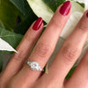a 0.95 Carat Old Cut Diamond Engagement Ring with 6 smaller diamonds set in Platinum on hand