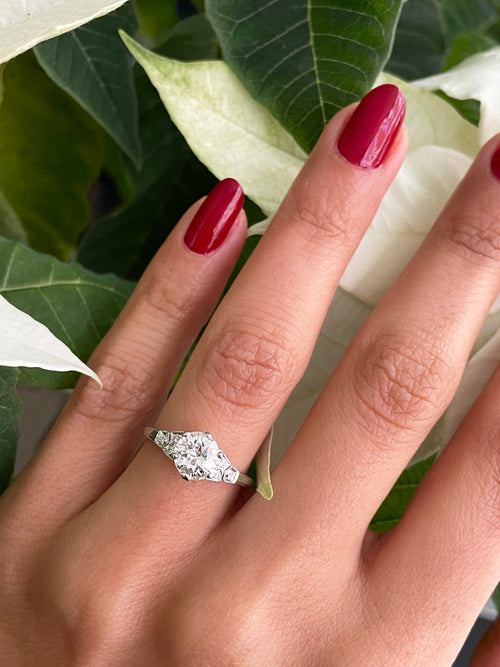 a 0.95 Carat Old Cut Diamond Engagement Ring with 6 smaller diamonds set in Platinum on hand