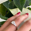 a 0.95 Carat Old Cut Diamond Engagement Ring with 6 smaller diamonds set in Platinum on hand