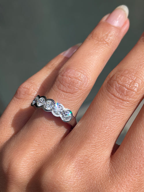 1.20ct diamond half eternity wedding band in platinum with five round brilliant cut rubover set diamonds