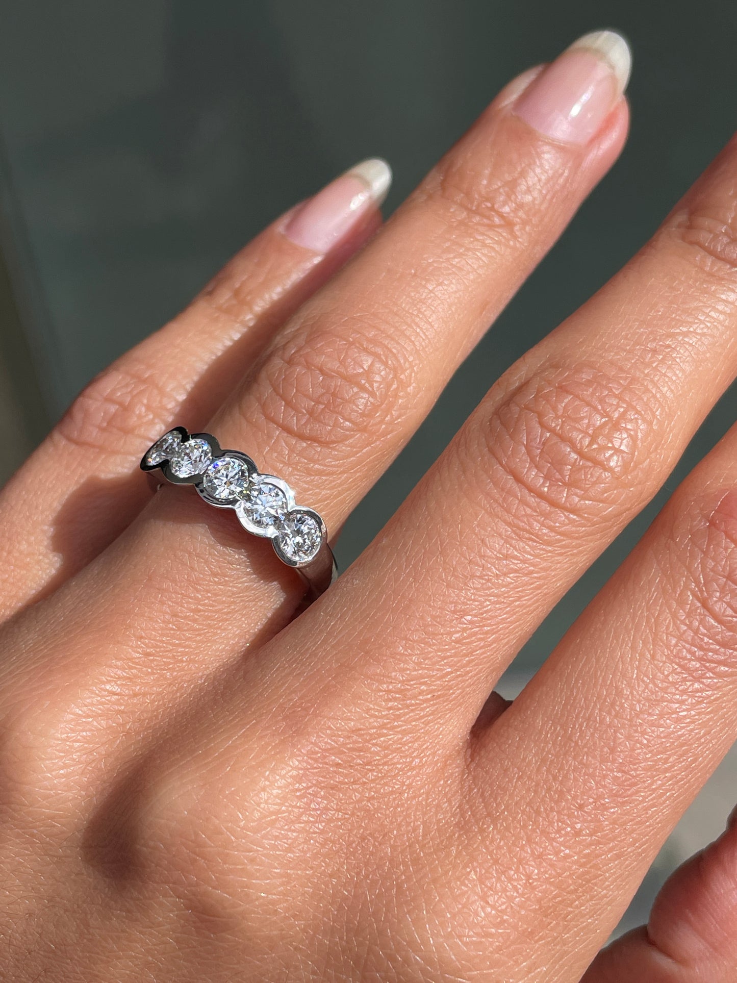 1.20ct diamond half eternity wedding band in platinum with five round brilliant cut rubover set diamonds