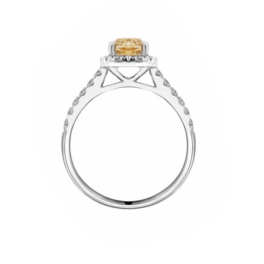 A champagne diamond engagement ring with white round brilliant cut diamonds set in a platinum band.