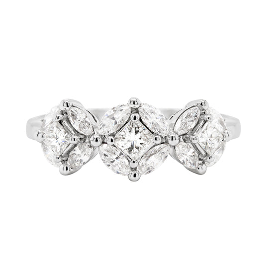 An 18 carat white gold trilogy diamond cluster engagement ring with three circular diamond clusters and a princess cut diamond in the center, set in a white gold band.