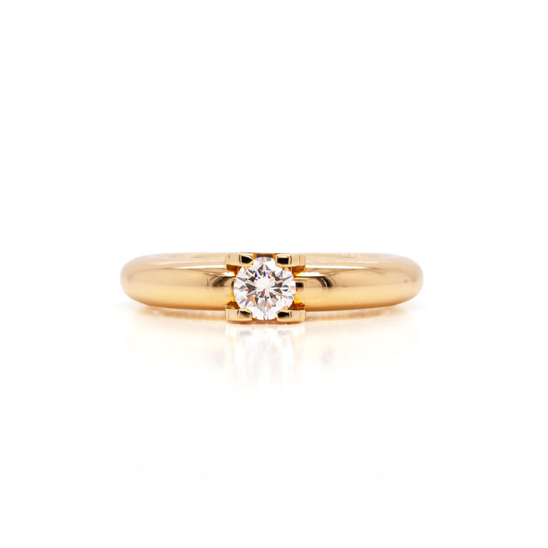 An 18 carat yellow gold Cartier 'C de Cartier' diamond solitaire engagement ring with a round brilliant cut center diamond.
