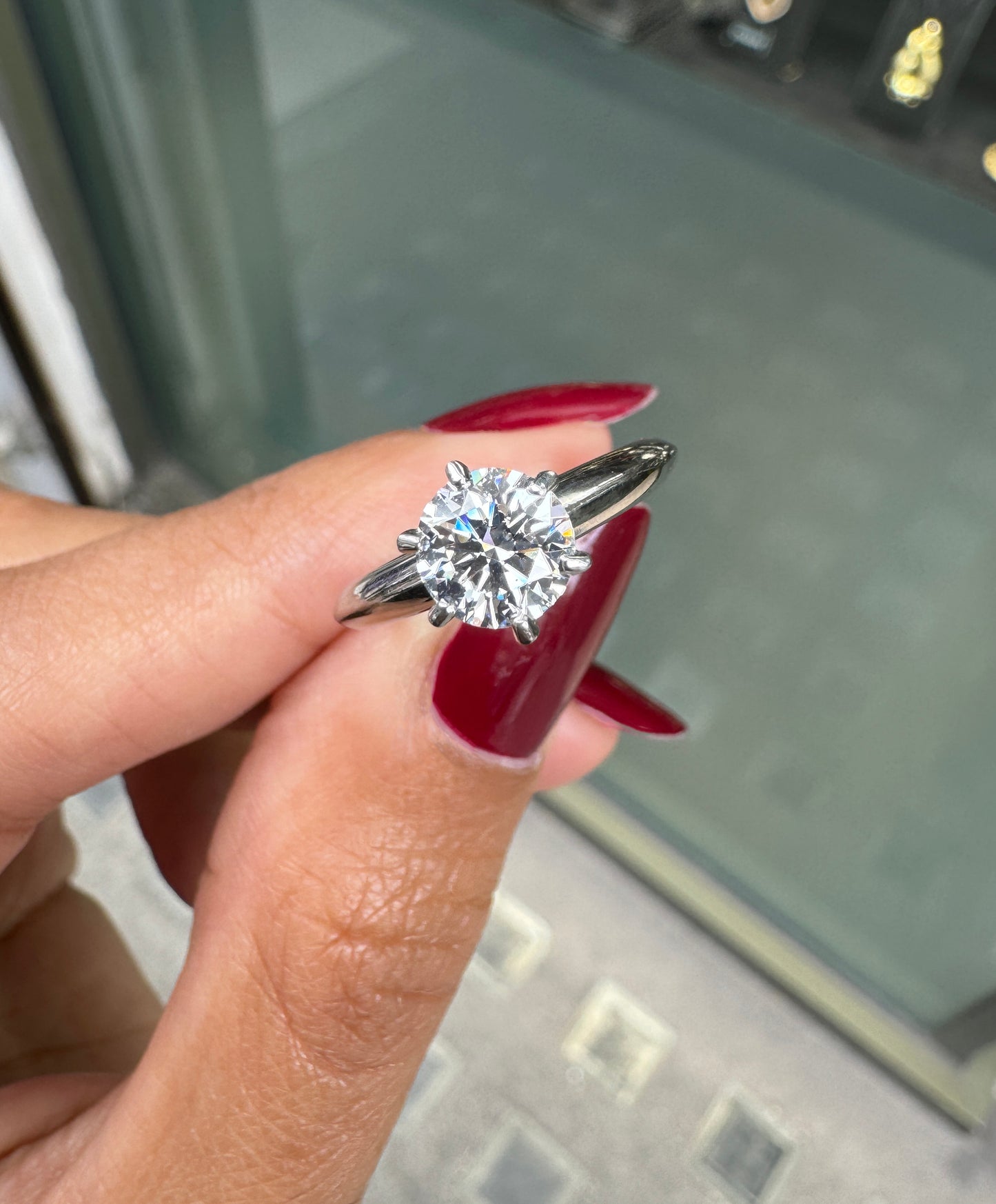 hand holding solitaire ring