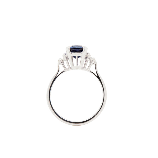 Silver ring with a blue gemstone on a white background
