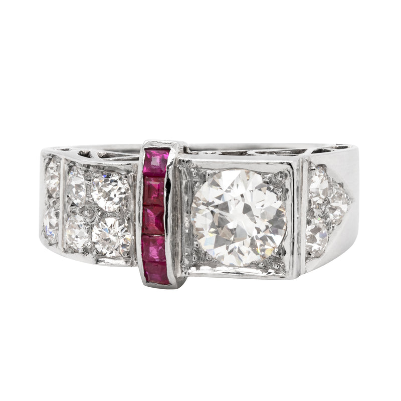 An art deco engagement ring with a central old European cut diamond and side rubies set in a platinum mount.