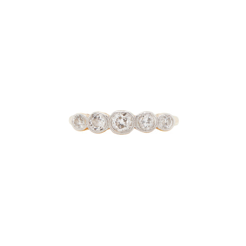 An 18 carat gold five-stone ring with old cut diamonds set in white gold bezels, featuring a yellow gold band.