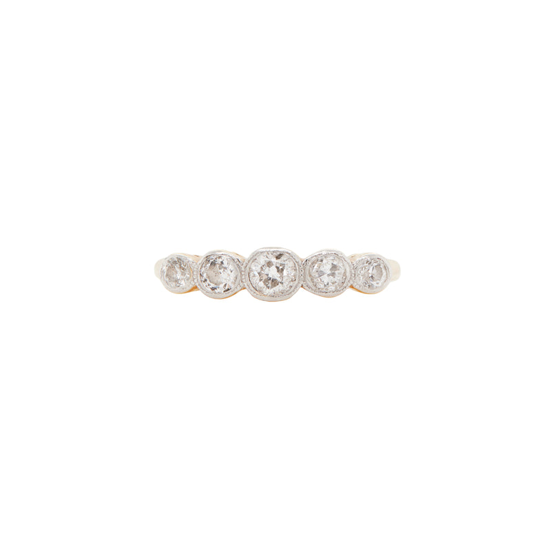 An 18 carat gold five-stone ring with old cut diamonds set in white gold bezels, featuring a yellow gold band.