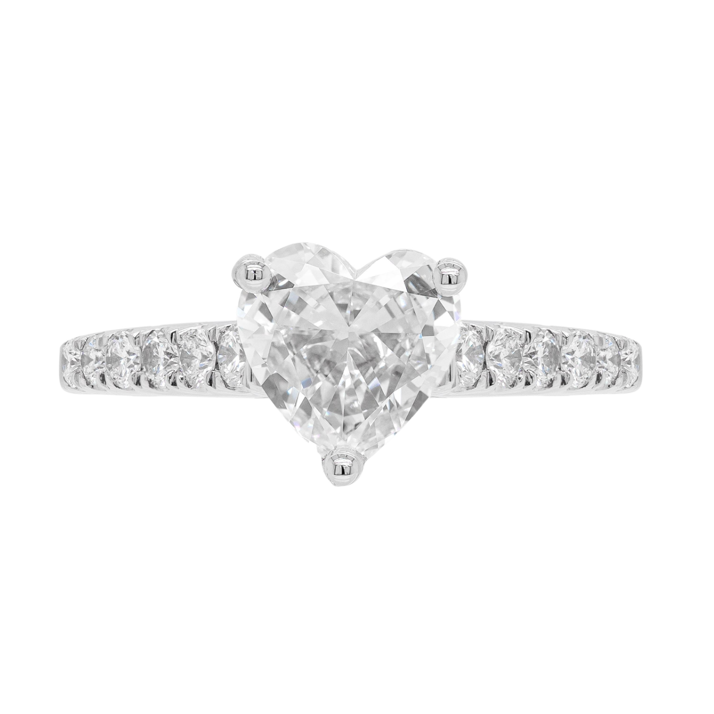 A heart-shaped diamond engagement ring with smaller round brilliant cut diamonds set in a platinum band.