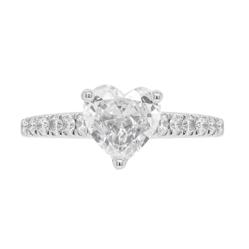A heart-shaped diamond engagement ring with smaller round brilliant cut diamonds set in a platinum band.