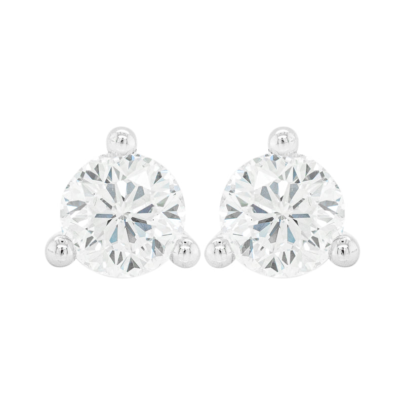 A pair of 18 carat white gold stud earrings with a clear, heart-shaped butterfly back and a central diamond.