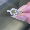 A champagne diamond engagement ring with white round brilliant cut diamonds set in a platinum band.