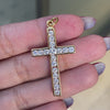 An 18 carat yellow gold diamond cross pendant with multiple round brilliant cut diamonds set within it.