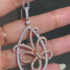An 18 carat white and rose gold diamond butterfly pendant with a chain.