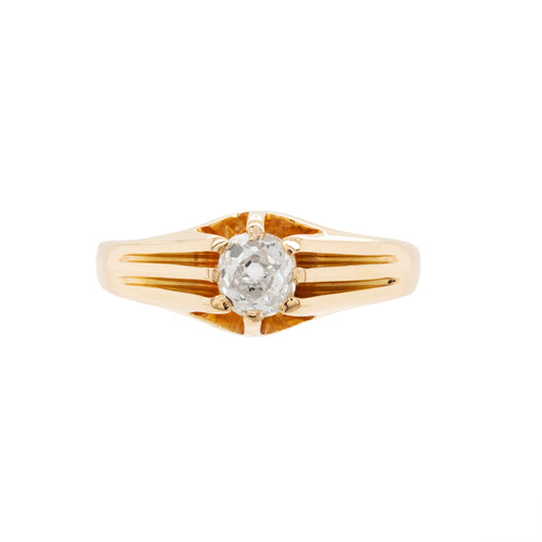 A 18 carat yellow gold vintage gypsy ring with a central old mine cut diamond, surrounded by smaller clear stones set in a raised eight claw, open back setting.