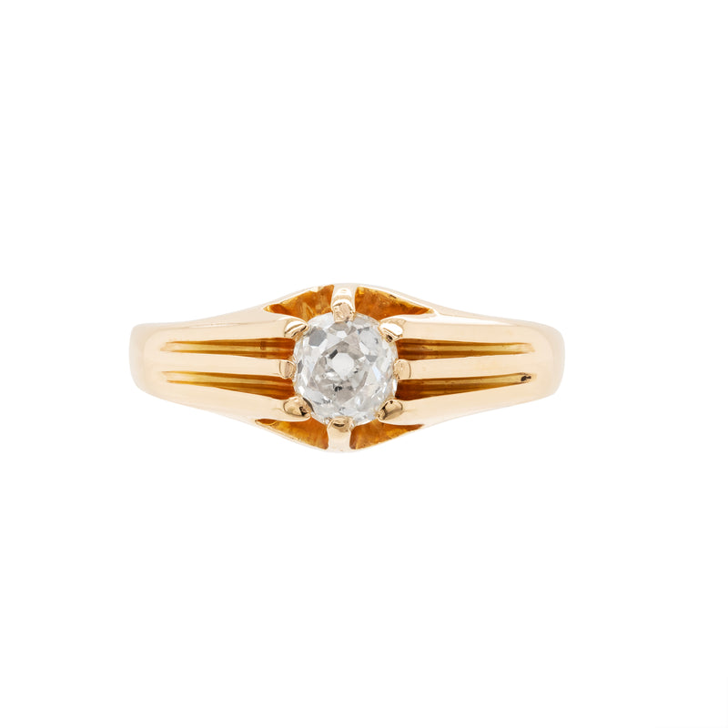 A 18 carat yellow gold vintage gypsy ring with a central old mine cut diamond, surrounded by smaller clear stones set in a raised eight claw, open back setting.