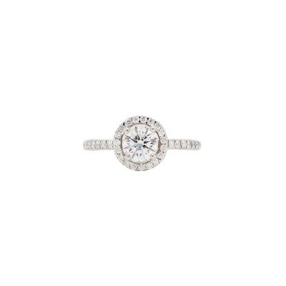A round halo cluster engagement ring with a central diamond surrounded by a halo of smaller round brilliant cut diamonds, set in a platinum band.