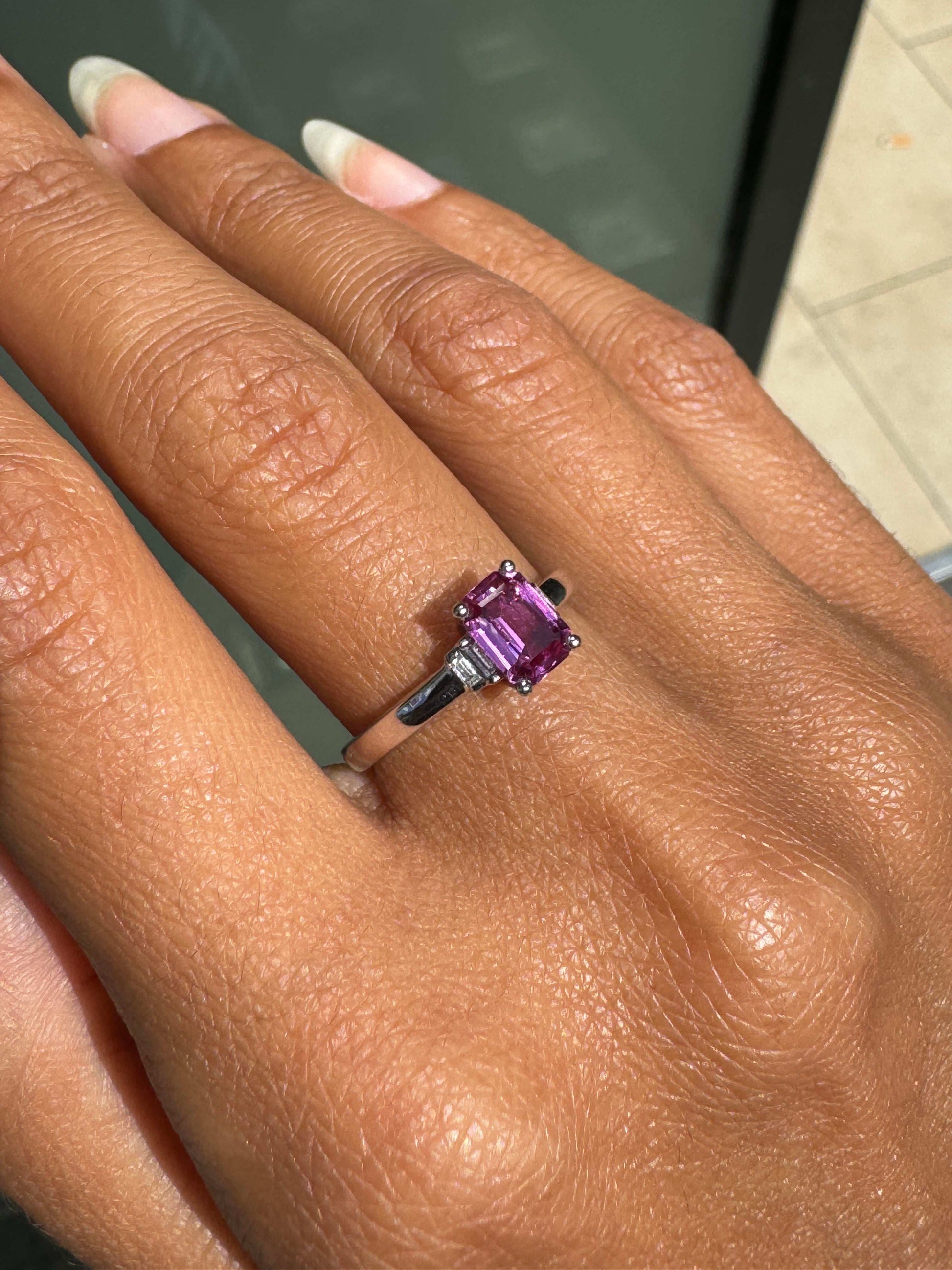 Ring with a pink gemstone on a person's finger