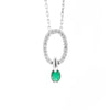 An 18 carat white gold oval pendant featuring a central emerald, surrounded by round brilliant cut diamonds set in a claw-like design.
