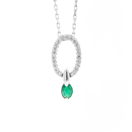 An 18 carat white gold oval pendant featuring a central emerald, surrounded by round brilliant cut diamonds set in a claw-like design.