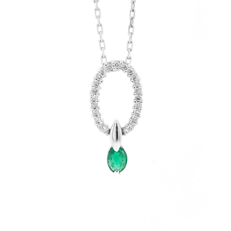 An 18 carat white gold oval pendant featuring a central emerald, surrounded by round brilliant cut diamonds set in a claw-like design.