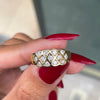 An 18 carat yellow gold lattice band ring with round brilliant cut diamond on hand