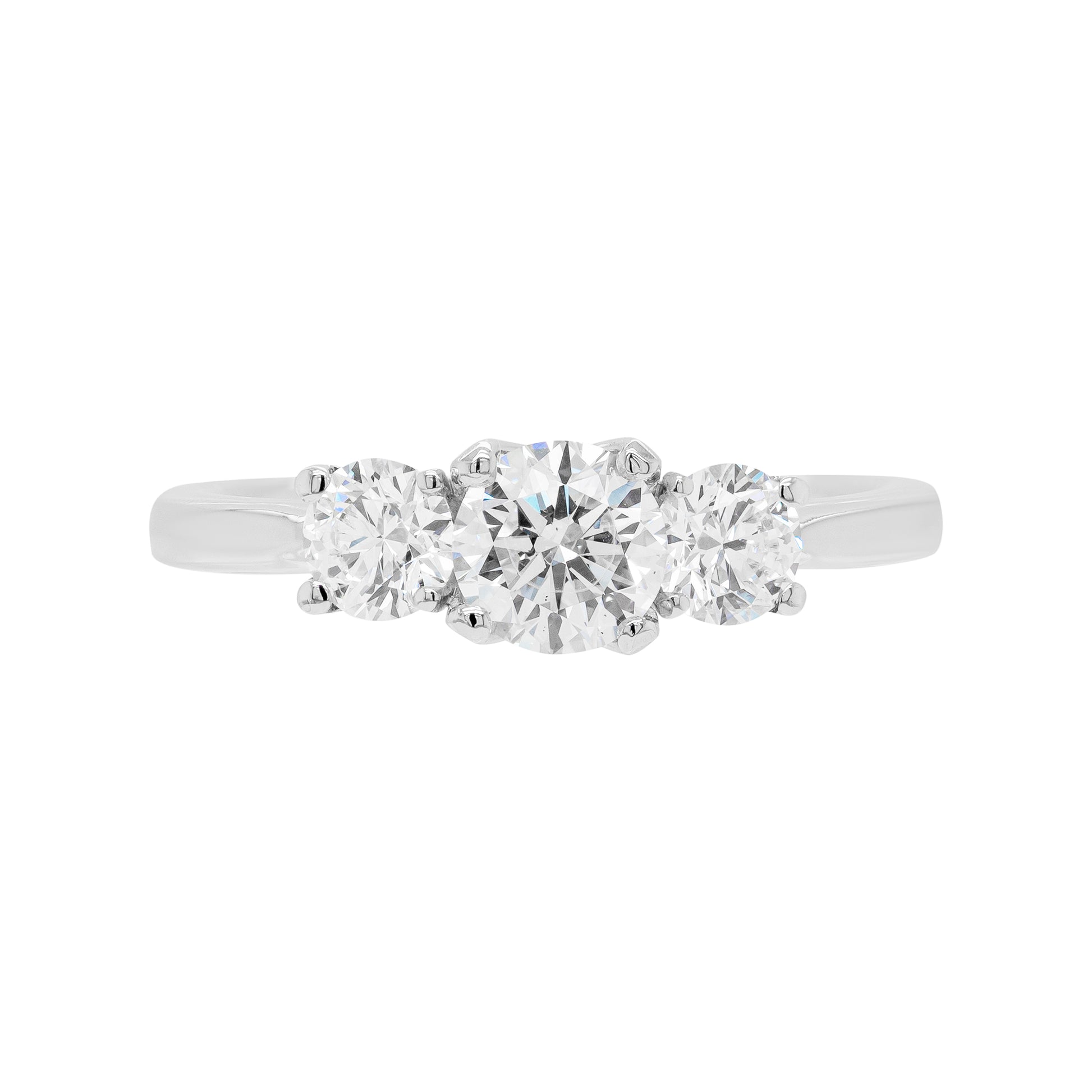 A platinum engagement ring with a central round brilliant cut diamond and two smaller round cut diamonds on the sides, set in an open-work gallery.