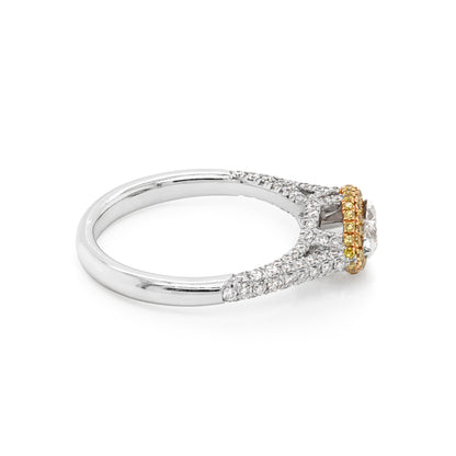 A marquise diamond engagement ring with a halo of round yellow diamonds set in rose gold, with smaller white round brilliant cut diamonds set in a contrasting band of platinum. side view