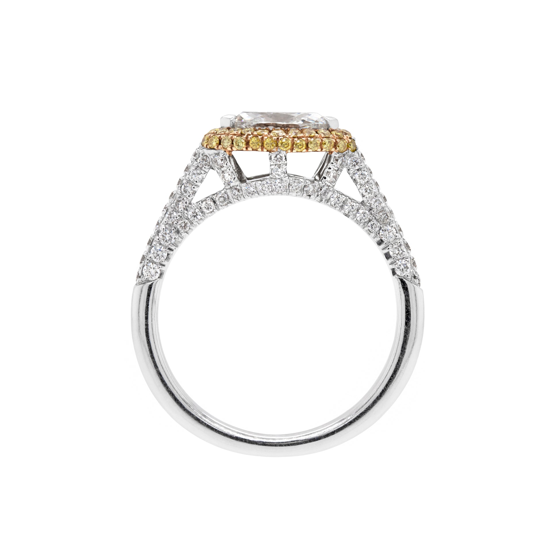 A marquise diamond engagement ring with an east west setting  halo of round yellow diamonds set in rose gold, with smaller white round brilliant cut diamonds set in a contrasting band of platinum. side view