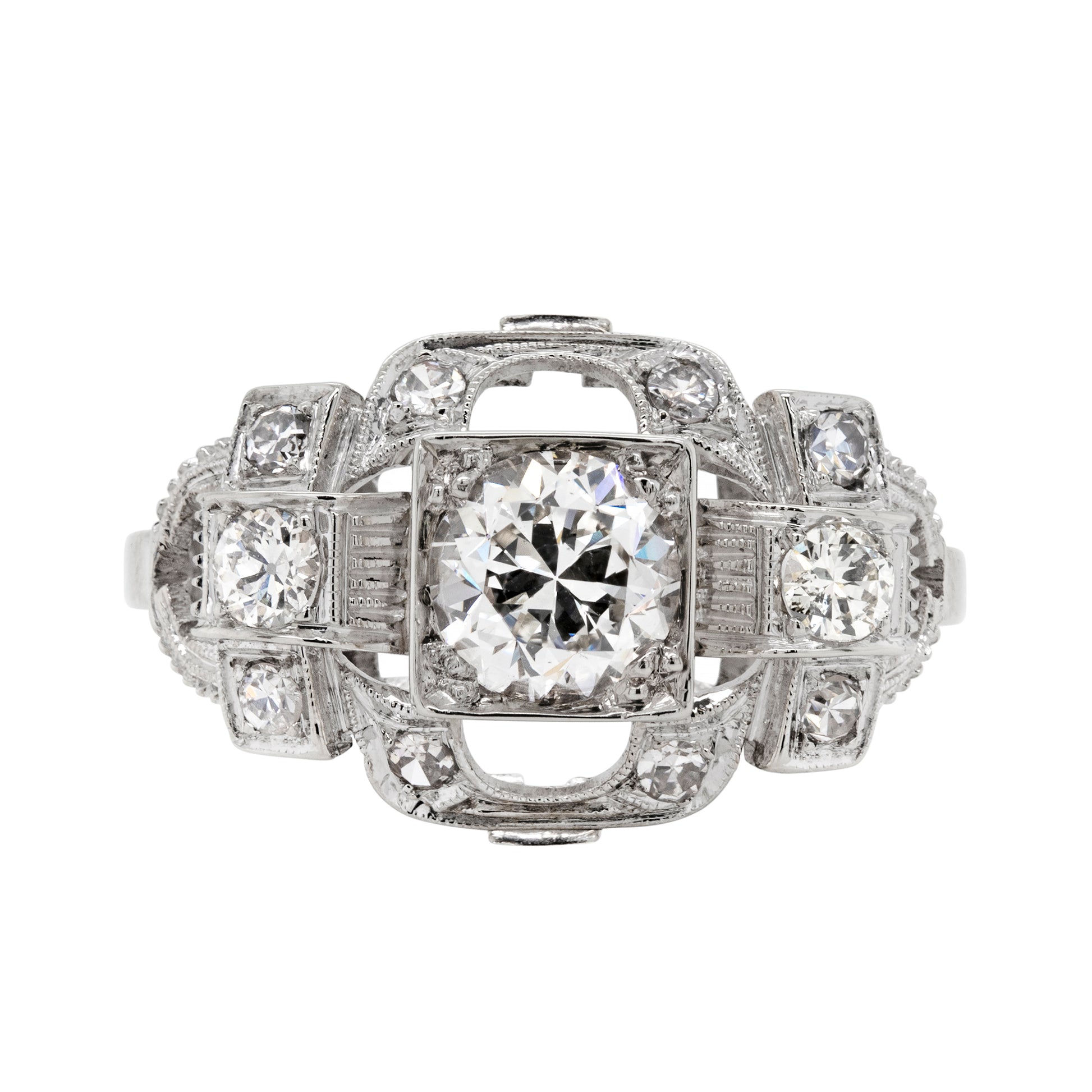 An Art Deco style engagement ring with a central old cut diamond and additional diamonds set in a platinum mount with open work detailing.