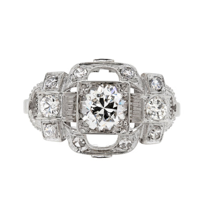 An Art Deco style engagement ring with a central old cut diamond and additional diamonds set in a platinum mount with open work detailing.