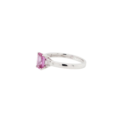 Silver ring with a pink sapphire on a white background