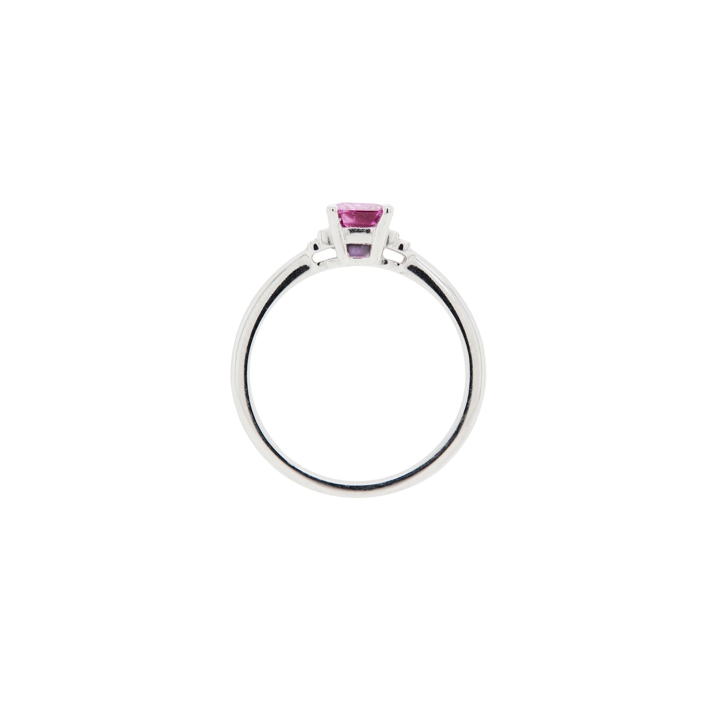 white gold ring with a pink sapphire on a white background