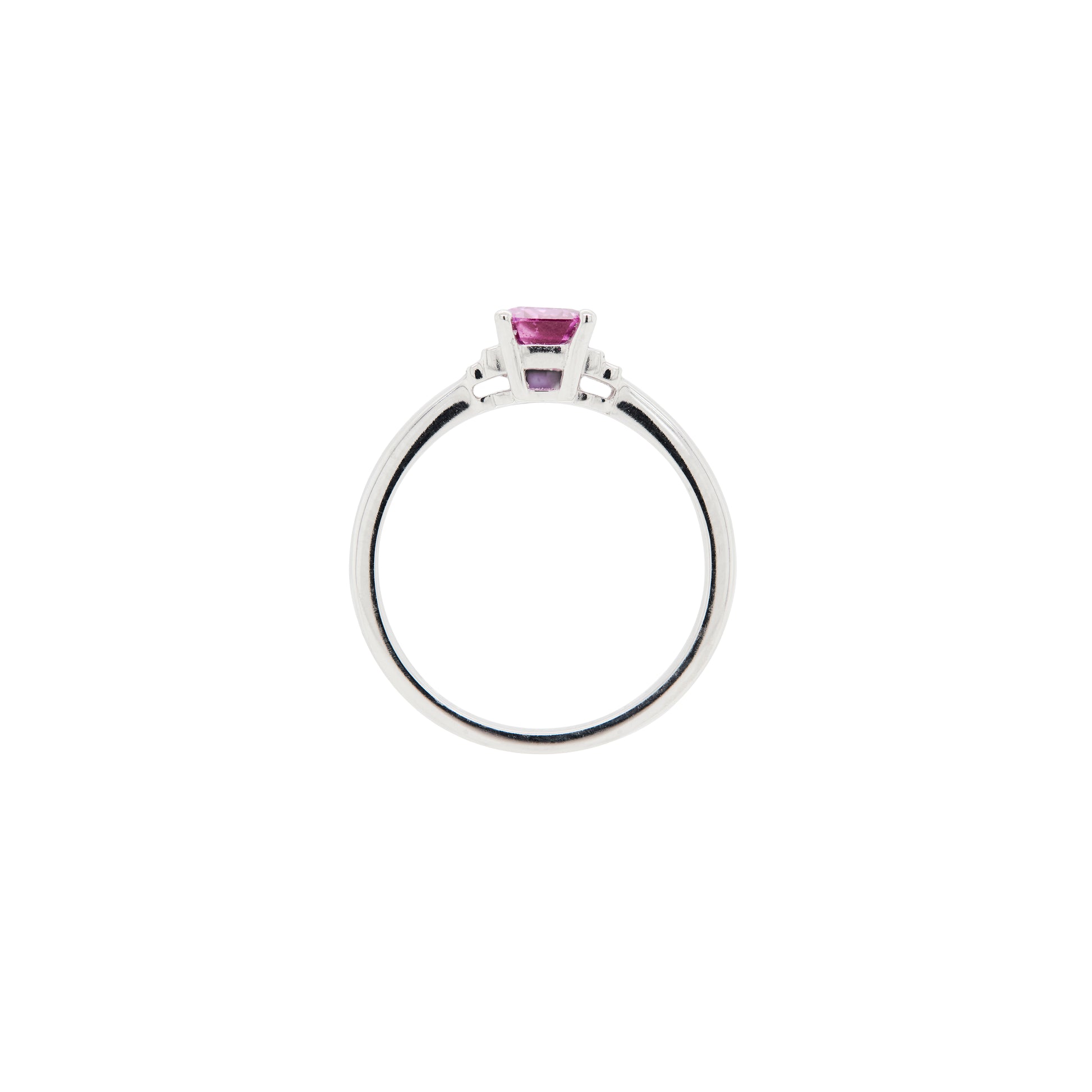 white gold ring with a pink sapphire on a white background