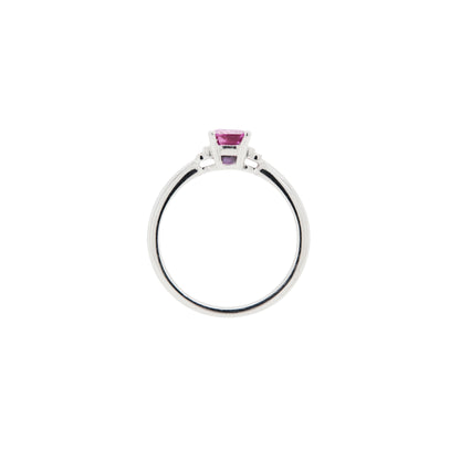 white gold ring with a pink sapphire on a white background