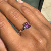 Ring with a pink gemstone on a person's finger