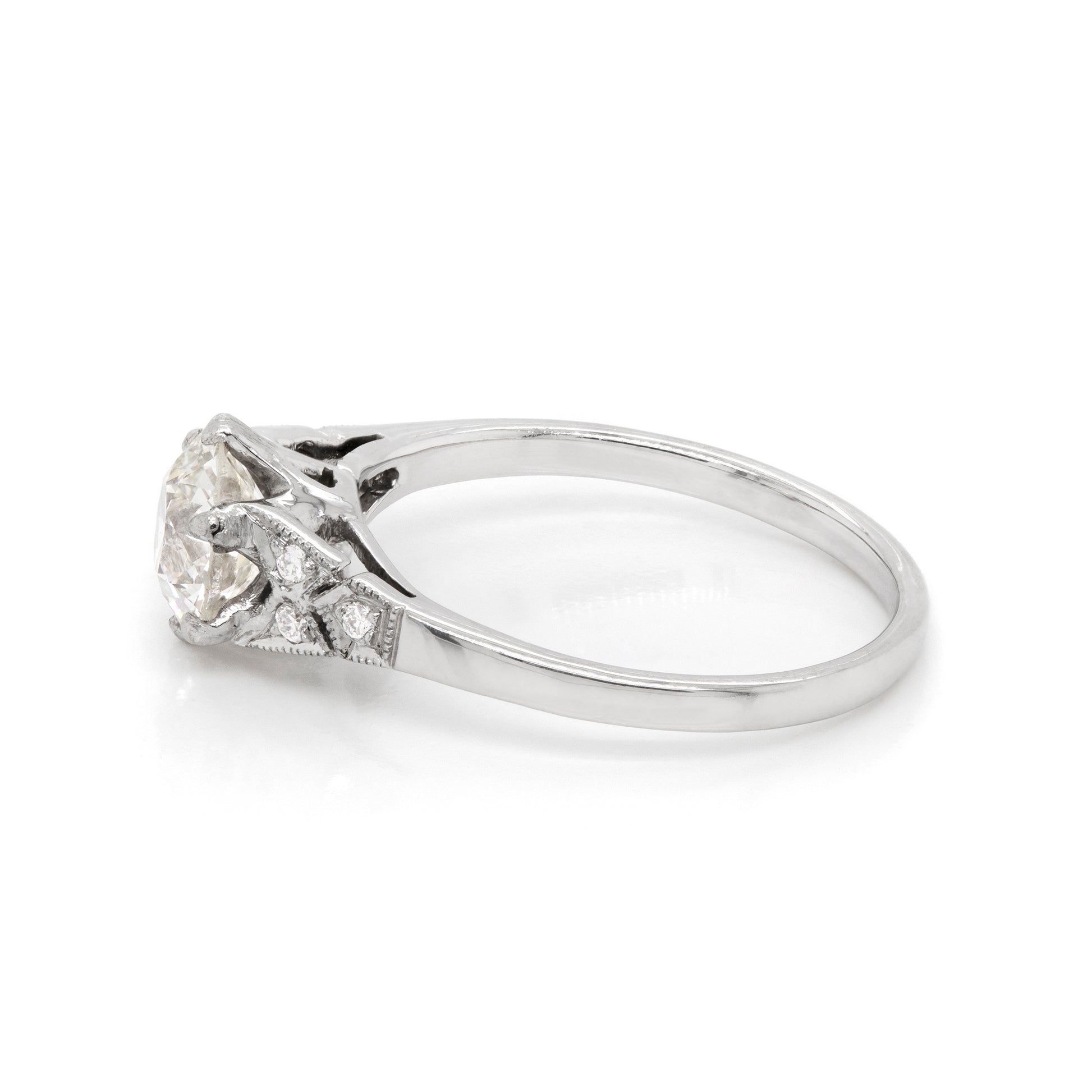 a 0.95 Carat Old Cut Diamond Engagement Ring with 6 smaller diamonds set in Platinum