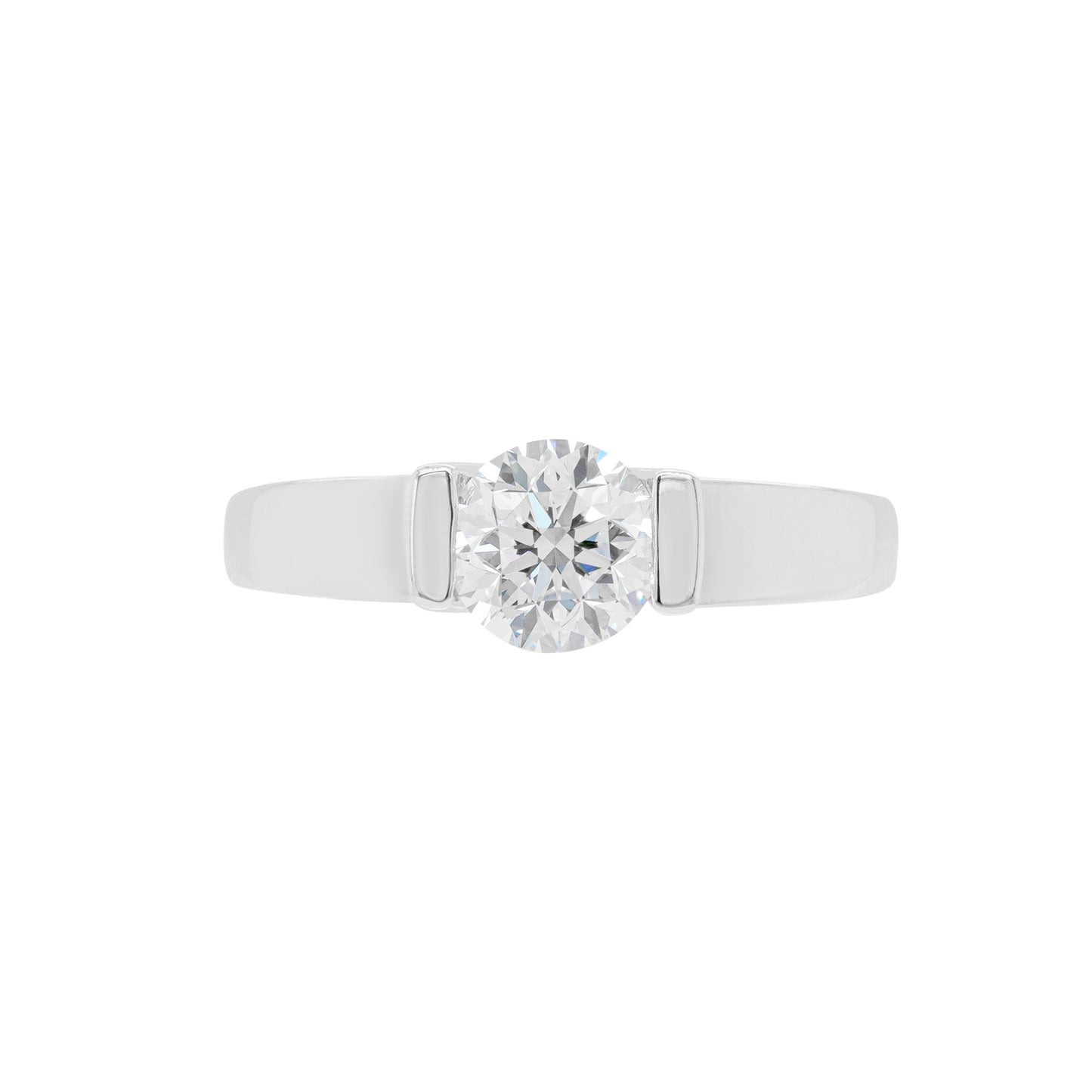 A white gold engagement ring with a round brilliant cut diamond centerpiece, set in a tapered platinum band.