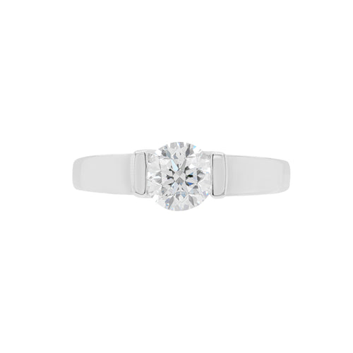 A white gold engagement ring with a round brilliant cut diamond centerpiece, set in a tapered platinum band.