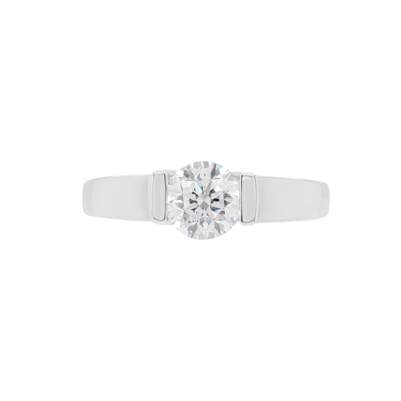 A white gold engagement ring with a round brilliant cut diamond centerpiece, set in a tapered platinum band.