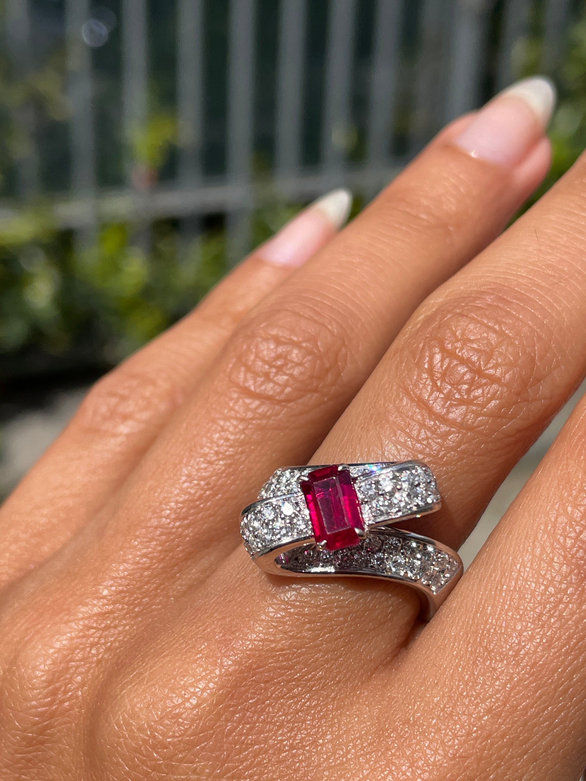 18ct white gold ribbon ring with a 1.04ct emerald cut ruby and 1.30ct diamonds on hand