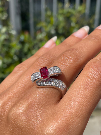 18ct white gold twisted ribbon dress ring with 1.04ct emerald cut ruby centre and 1.30ct round brilliant cut diamonds inlaid in two rows