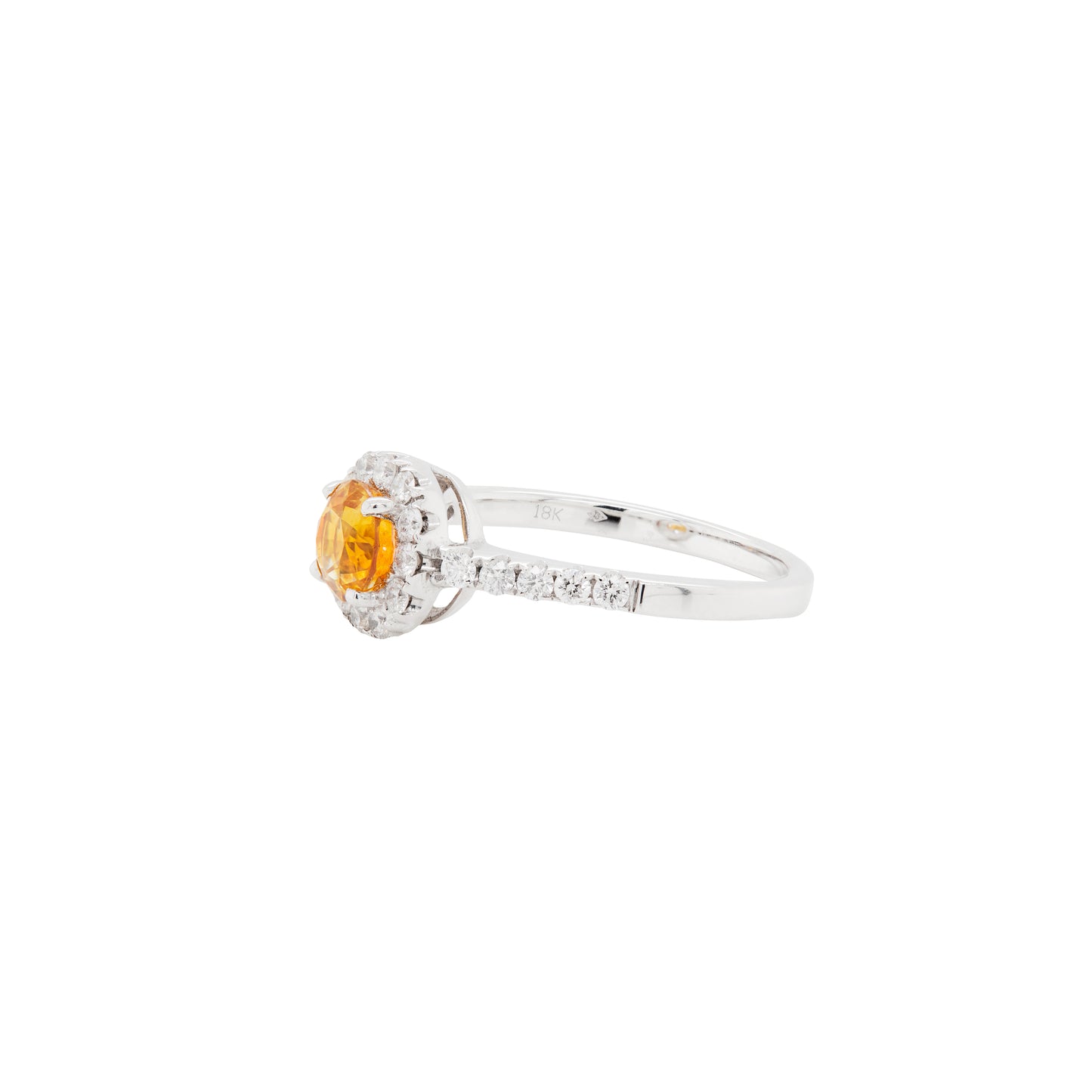 Diamond ring with a yellow gemstone on a white background