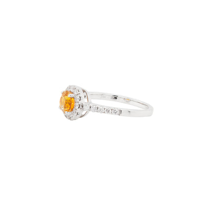 Diamond ring with a yellow gemstone on a white background