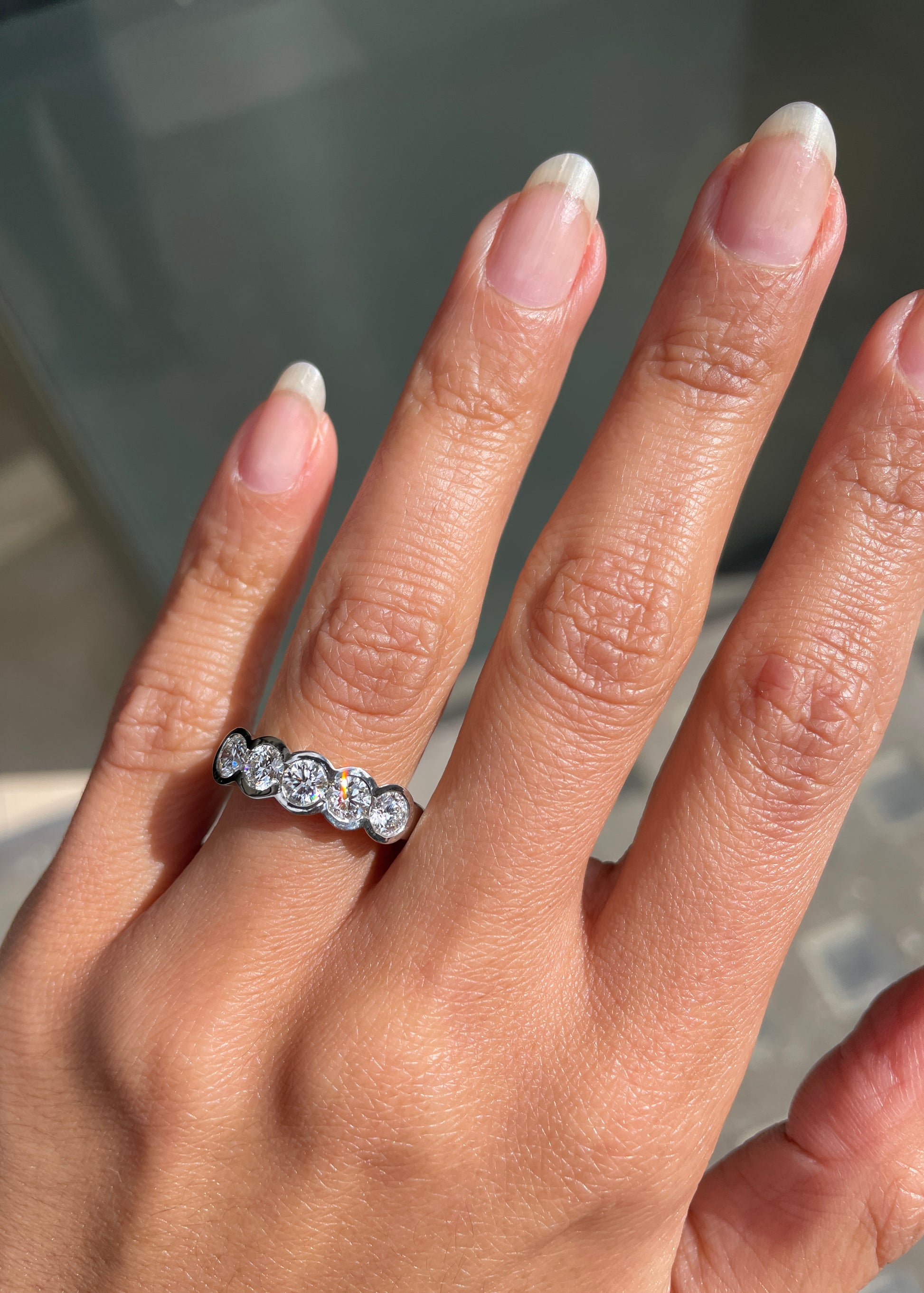 1.20ct diamond half eternity wedding band in platinum with five round brilliant cut rubover set diamonds